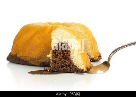 Group of one whole one slice of fresh baked marble gugelhupf sweet bread variety with cake spatula isolated on white background Stock Photo