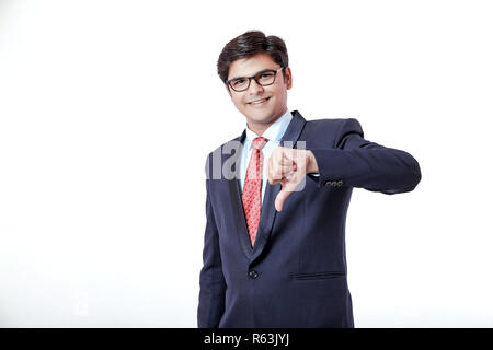 Young Indian businessman showing thumb down Stock Photo