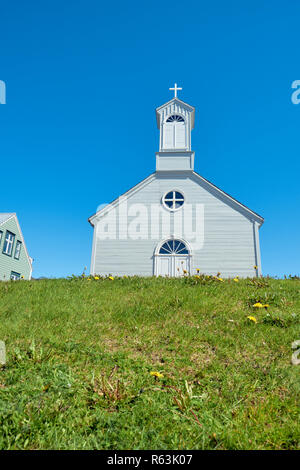 An example of a typical Icelandic architectural style wooden timbered church from a low angle in the summer. Stock Photo