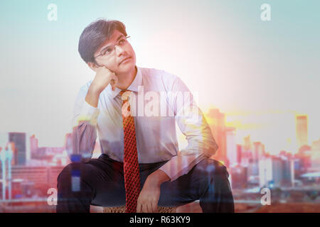 Young Indian business man thinking Stock Photo