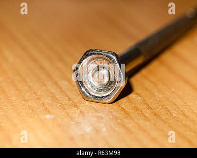 close up of small screw driver nail screw head metal macro Stock Photo