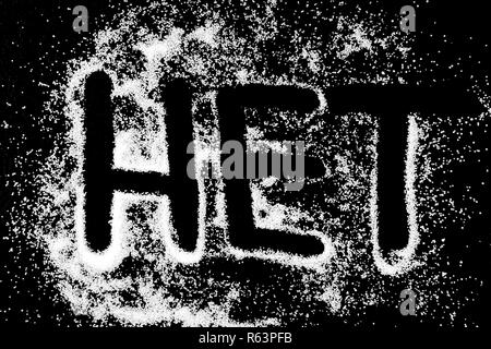 No word in russian language symbol drawing by finger on white snow salt powder on black background. Capital letters Stock Photo