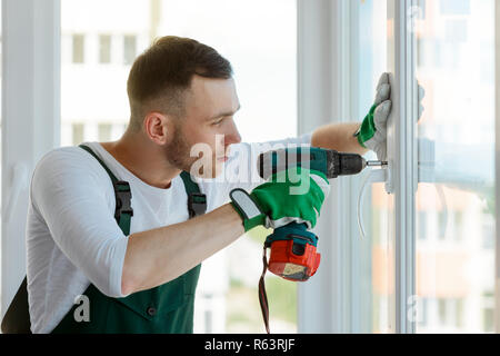 Handyman using a cordless screwdriver Stock Photo