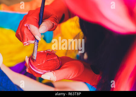 Stage makeup artist with paintbrush painting wound on face of young man  Stock Photo - Alamy