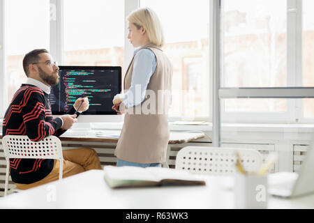 Young lady working with programmer in office Stock Photo