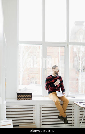 Happy relaxed hipster manager in office Stock Photo