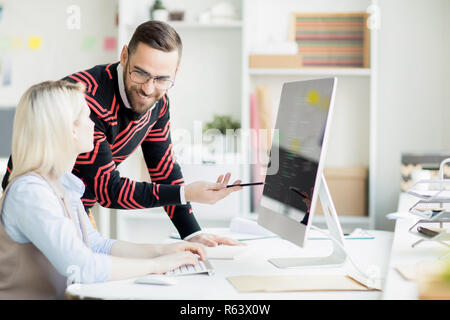 Cheerful colleagues discussing app development Stock Photo