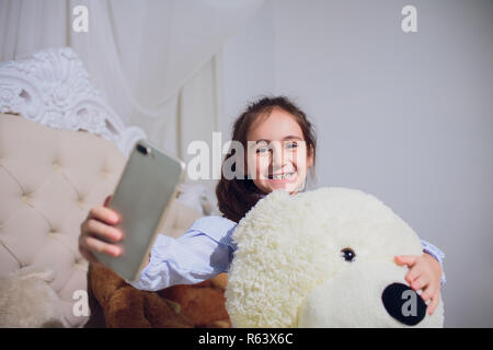 girl treats the bear and make selfie photo. Stock Photo