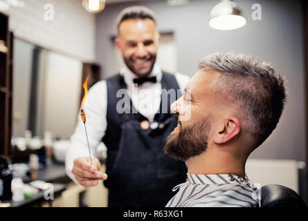 Hipster man client visiting haidresser and hairstylist in barber