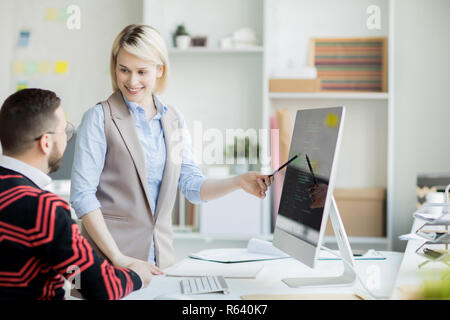 Confident pretty web designer presenting her project Stock Photo
