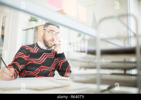 Confident male manager talking by mobile phone Stock Photo