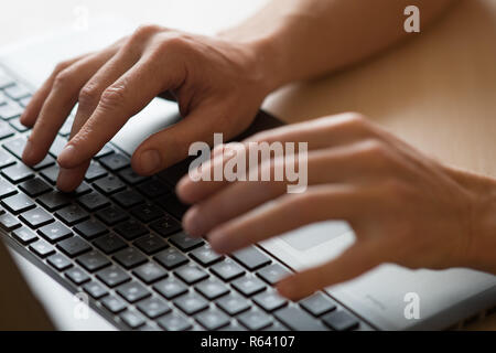 Men hands typing on a keyboard of laptop Stock Photo