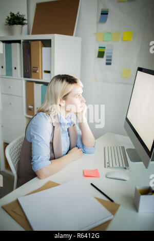 Tired lady viewing information on computer Stock Photo
