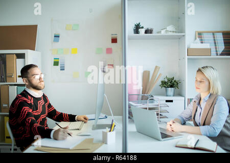 Unhappy marketing specialists working in office Stock Photo