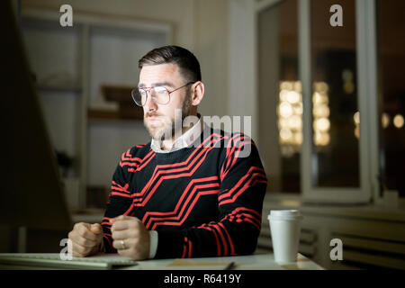 Exhausted manager trying to work at night Stock Photo