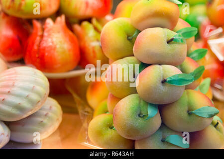 Cakes with marzipan in the form of peach. Stock Photo