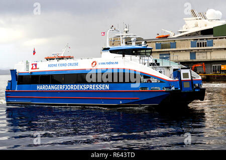 High speed passenger catamaran Rygerfonn arriving  in the port of Bergen, Norway, on a rainy and foggy day Stock Photo