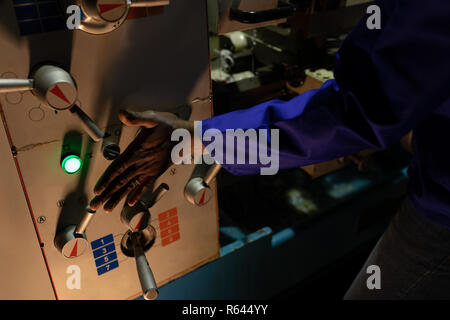 Worker operating control panel in glass factory Stock Photo