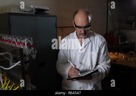 Worker using digital tablet in glass factory Stock Photo