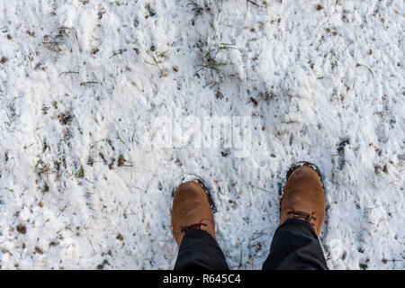 Mans feet in winter boots on the fresh snow. Stock Photo