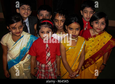 Young kids like dressing up, this is a photo of group of Indian school children dressed as adults for a school fancy dress competition Stock Photo