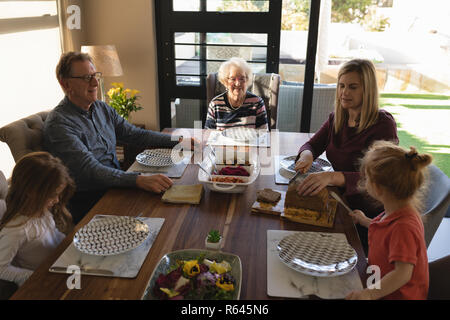 Multi generation family having food on dining table Stock Photo