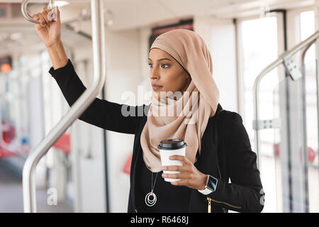 Woman looking through window while travelling in train Stock Photo