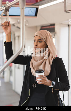 Woman looking through window while travelling in train Stock Photo