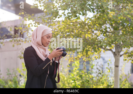 Woman clicking in camera from railing Stock Photo