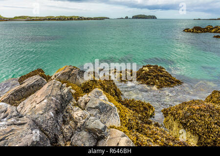 Seascape of rocks, seaweed and clear turquoise water at Bosta Beach, Great Bernera, Isle of Lewis, Outer Hebrides, Scotland, UK Stock Photo