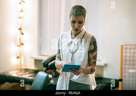 Beautiful young woman with hands covered in tattoos Stock Photo