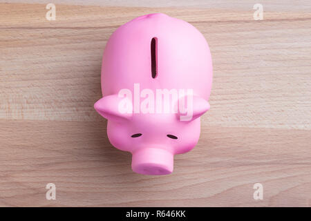 Piggy bank on wooden table Top view Stock Photo