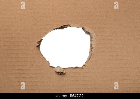 Ripped hole in brown cardboard isolated on white Stock Photo