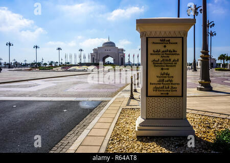 Abu Dhabi Monument Like Road Sign with Rawal Fountain and Oriental Arched Gate at Background Stock Photo