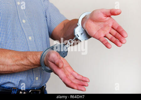 Handcuffs on the wrists of the detained man. Police division. Stock Photo