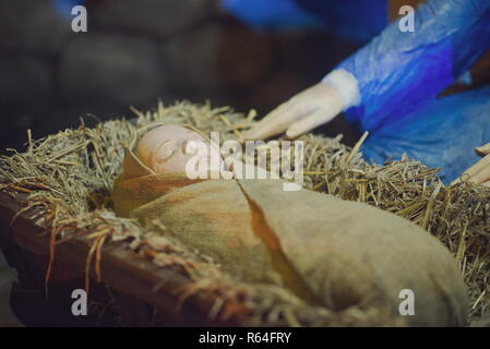 Rustic Baby Jesus Figurine in Manger Closeup Stock Photo