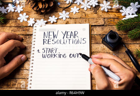 Person writing new year resolutions first person view Stock Photo