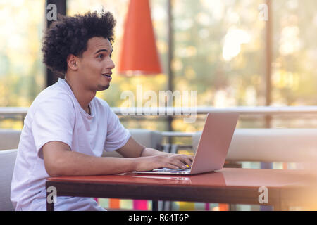 Image of african american businessman working on his laptop. Handsome young man at his desk. Stock Photo