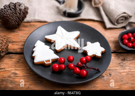 Gingerbread christmas cookies in the black plate. Stock Photo