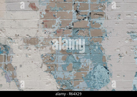 Light abstract rare background of brick wall with spots and layers of old paint with scratches, cracks. Futuristic painted wall Stock Photo