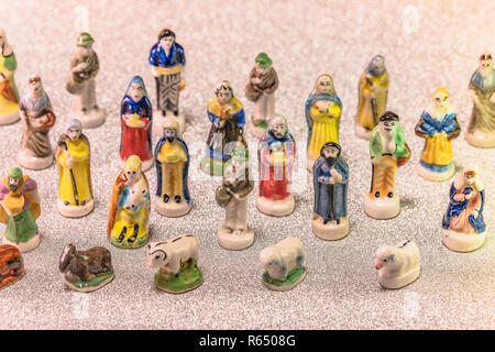 Small figurines of santons from French Provence used like beans of the cake of the kings during the Epiphany also called the Little Christmas on a gli Stock Photo