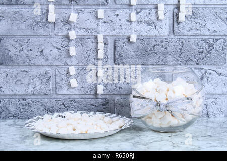 Diy marshmallow garland. Guide on photo how to make a decorative marshmallow garland, threads, needles and branches with your own hands. Handmade Chri Stock Photo