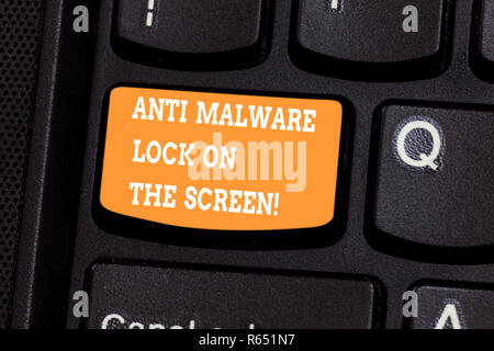 Handwriting text writing Anti Malware Lock On The Screen. Concept meaning Security safety against malware hacking Keyboard key Intention to create com Stock Photo