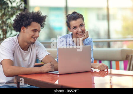 Two freelance working in coffee shop, Nomad worker conceptual, couple work together in cafe with laptop Stock Photo