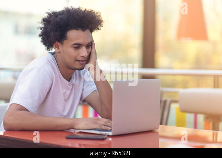 Image of african american businessman working on his laptop. Handsome young man at his desk. Stock Photo