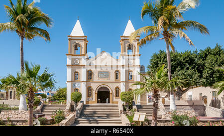 Front view of Parroquia San José the catholic church in old town San Jose del Cabo, Mexico, with two bell towers and palm trees on a sunny day. Stock Photo