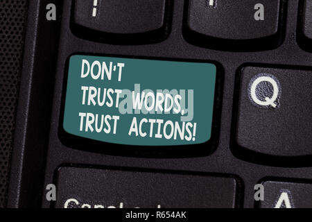 Conceptual hand writing showing Don T Trust Words Trust Actions. Business photo text Less talking more things done action taken Keyboard key Intention Stock Photo