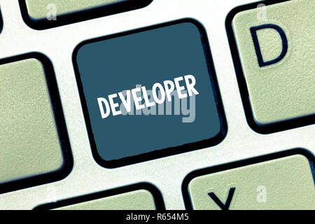 Writing note showing Developer. Business photo showcasing demonstrating or thing that develops grows or matures something Keyboard Intention to create Stock Photo
