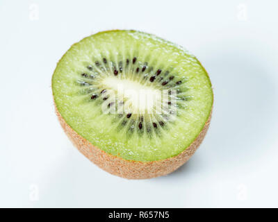 Freshly sliced kiwi fruit on white plate Stock Photo