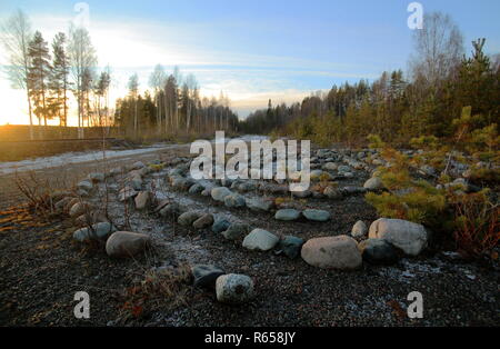 Meditative rock maze in the evening sun. Stock Photo